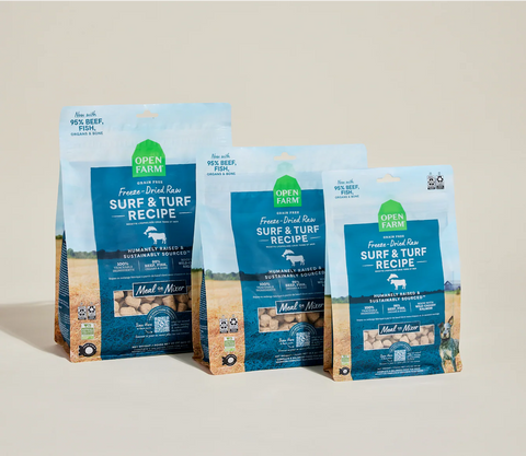 Three packages of Open Farm Surf & Turf recipe on a beige background
