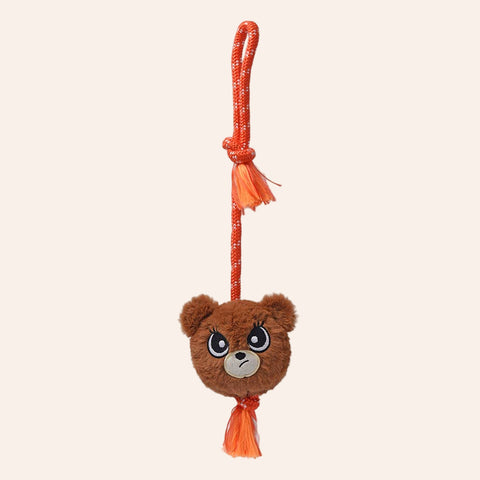 Plush bear toy with an orange rope on a white background