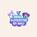 Sticker with cartoon dogs and text 'Easily Distracted by Dogs' on a beige background