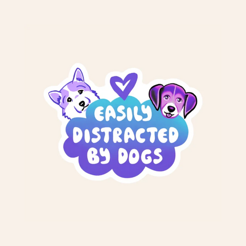 Sticker with cartoon dogs and text 'Easily Distracted by Dogs' on a beige background
