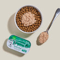 Pet food container with a spoonful of pet food on a beige background