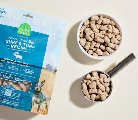 Open Farm freeze-dried raw pet food package with a bowl and scoop of pet food on a light background