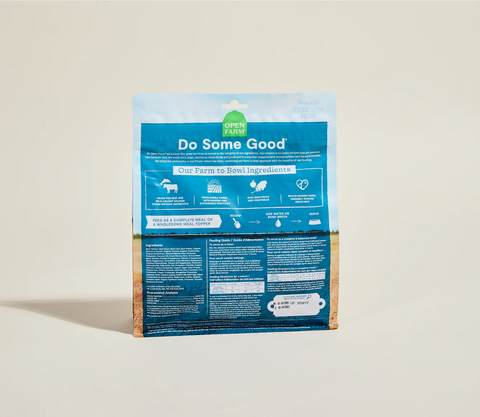 Package of Open Farm pet food with blue label on a beige background