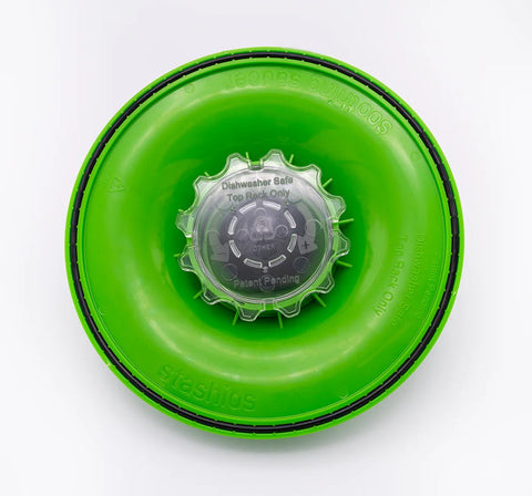 Green bottle cap with a clear center on a white background
