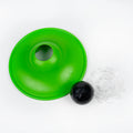Green plastic funnel-like object with a black ball on a white background