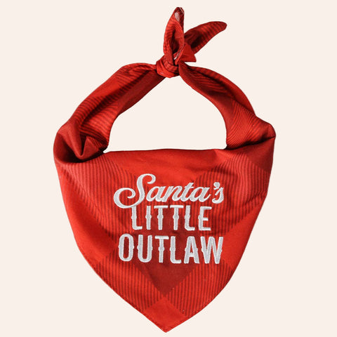 Red bandana with 'Santa's Little Outlaw' text on a white background